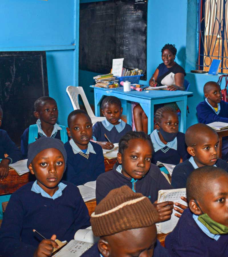 Children sitting in a classroom doing math problems